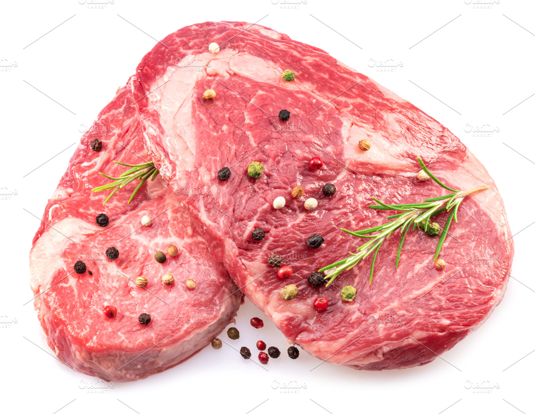 Two fresh ribeye steaks with peppercorn and rosemary isolated on, a Food & Drink Photo by Volff