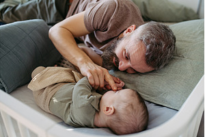 Father putting the baby to sleep, a Person Photo by HalfPoint