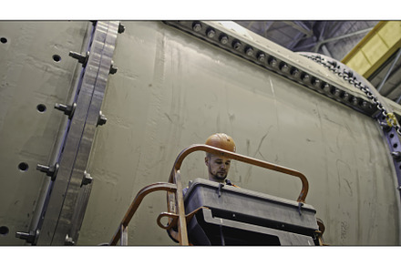 Worker on telescopic lift at factory, an Industrial Photo by Media Whale Stock