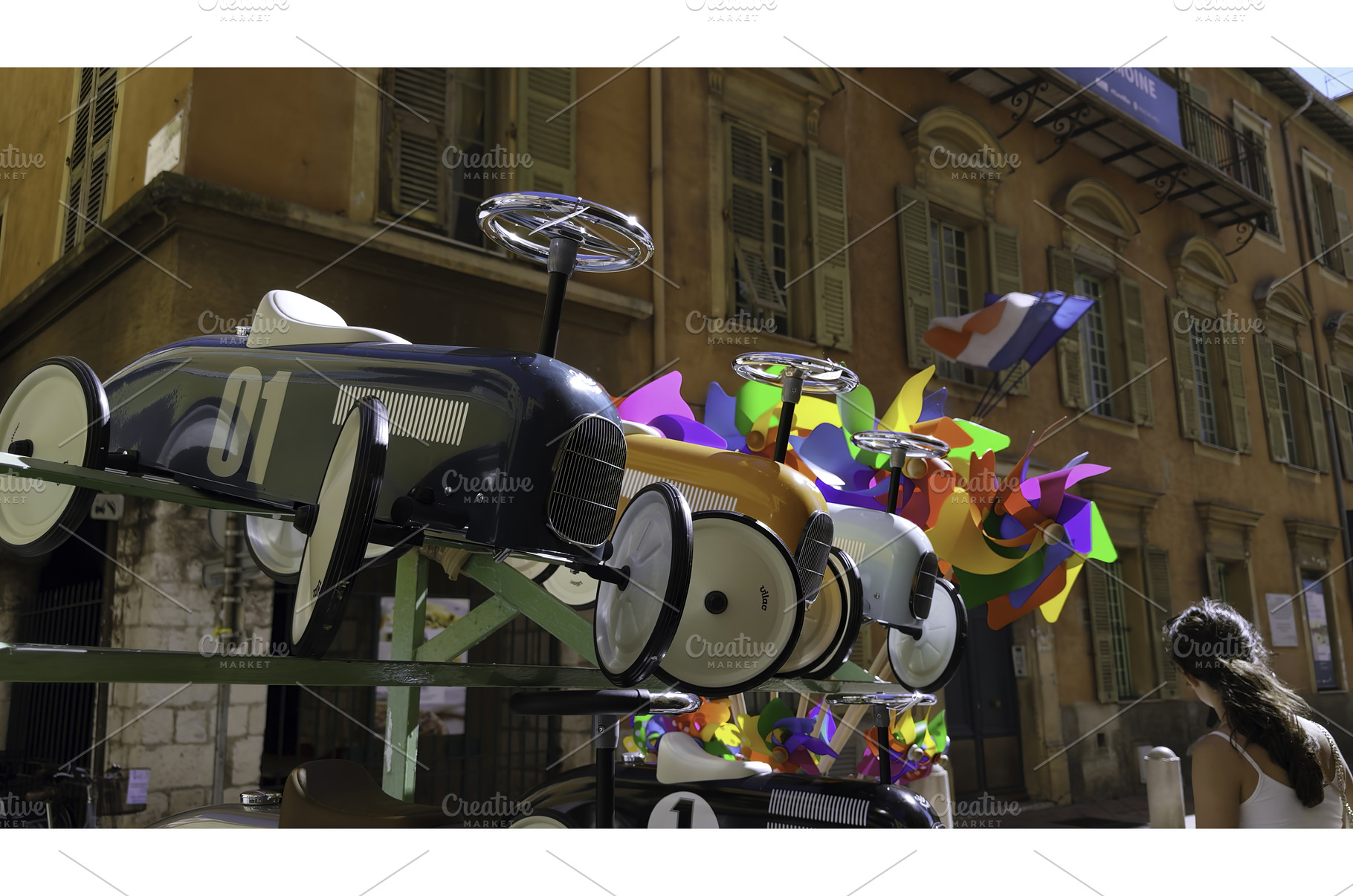 Colorful pinwheels spinning behind, an Architecture Photo by Media Whale Stock