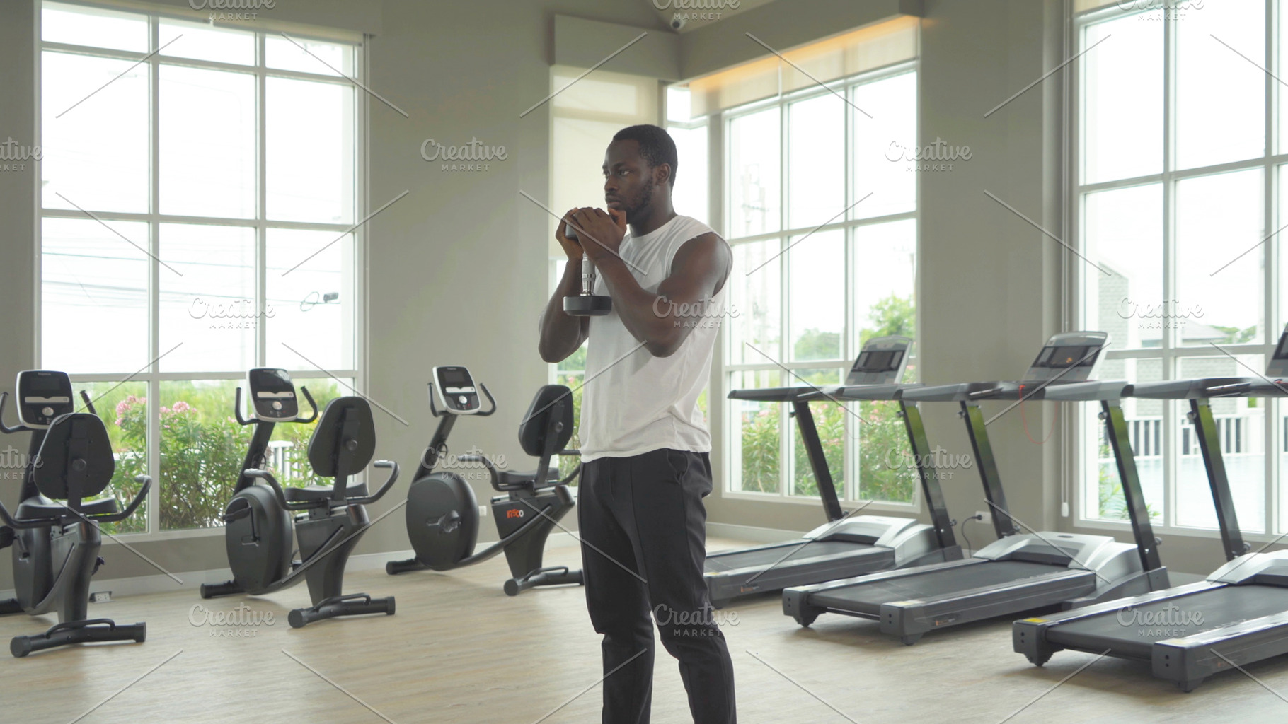Portrait of strong black african american man using fitness equi, a Photo by Tampatra