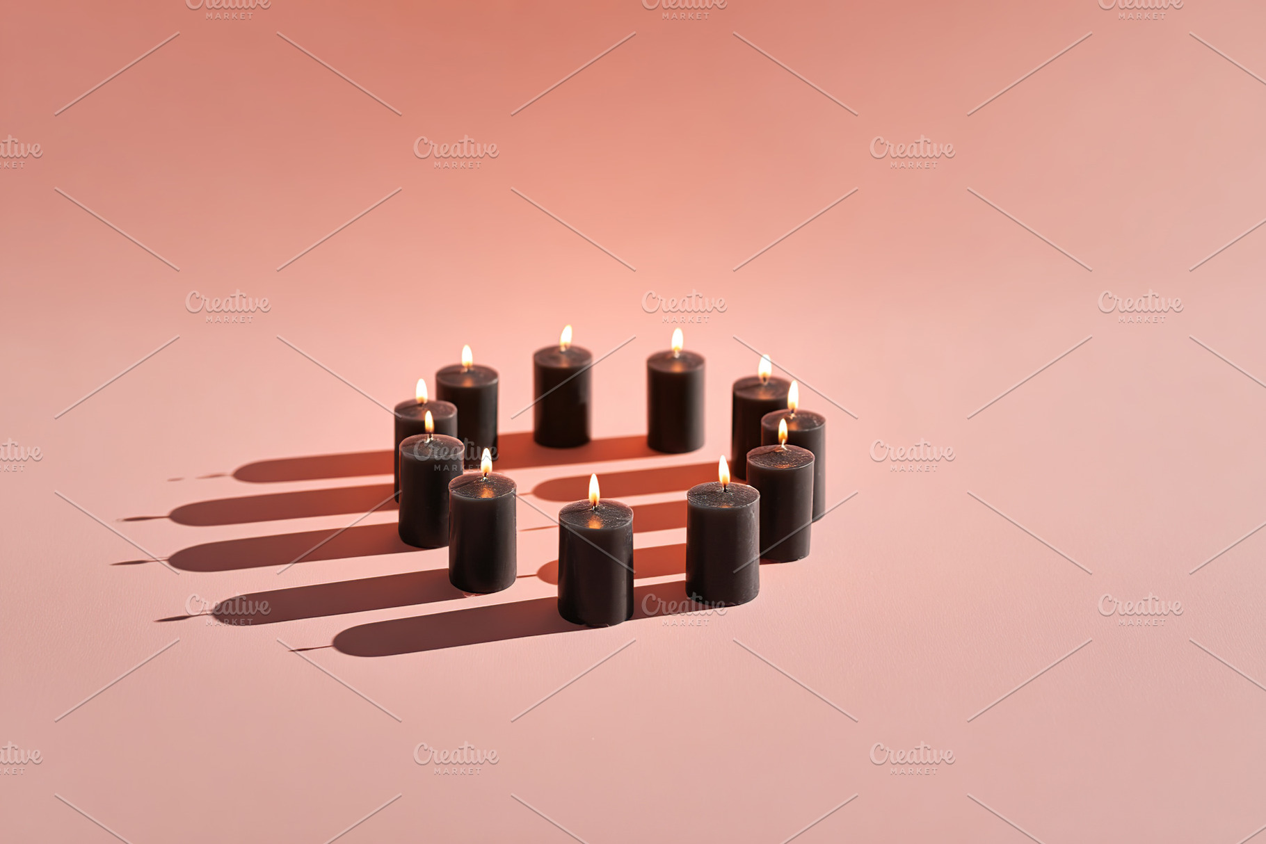 Candles arranged in a circle, casting soft shadows on a warm background, a Photo by AlyaAnd