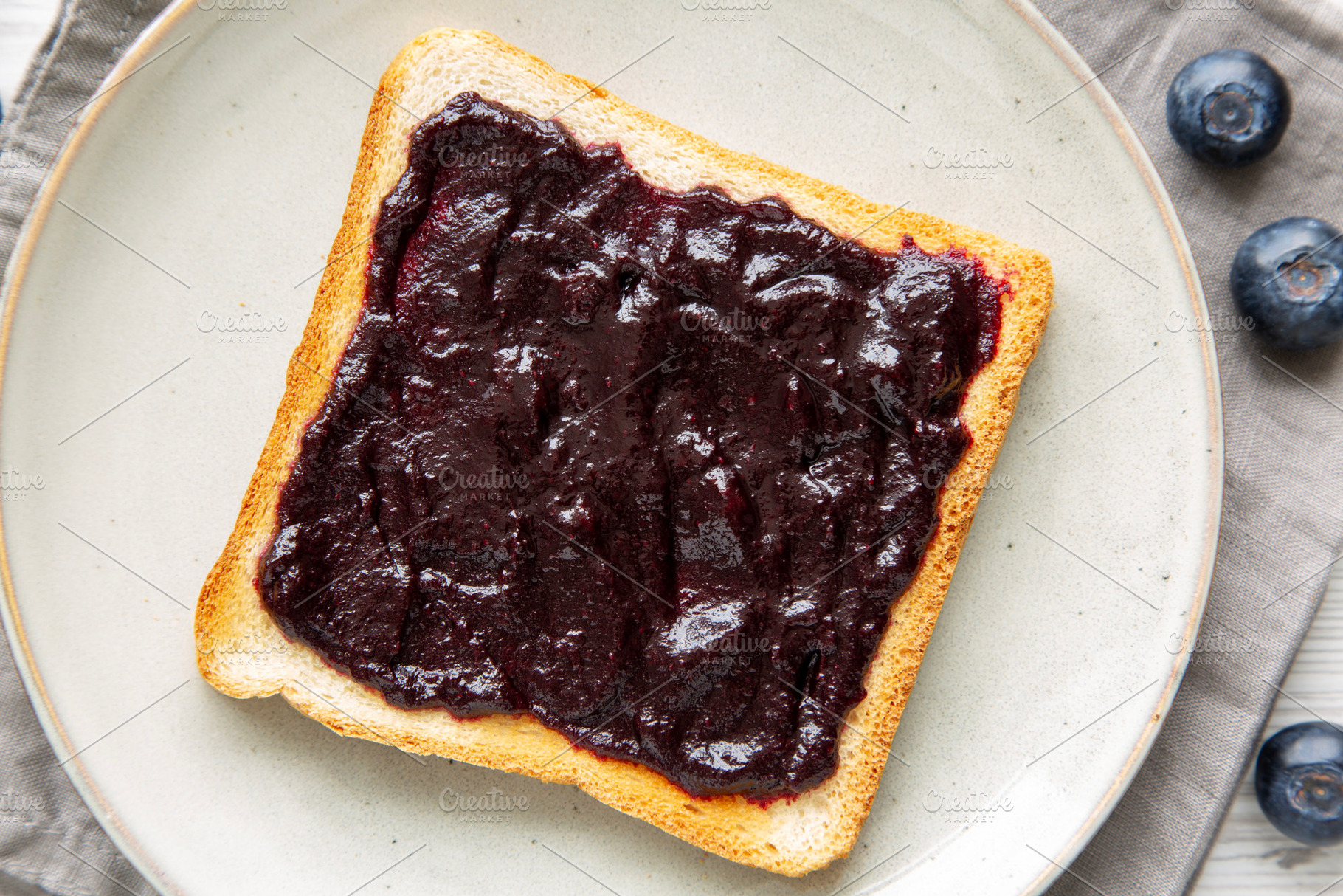 Healthy Blueberry Jelly and Toast on a Plate, top view. Close-up, a Food & Drink Photo by LiudmylaChuhunova