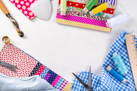 Colorful fabric pieces with sewing tools, an Industrial Photo by Rimma