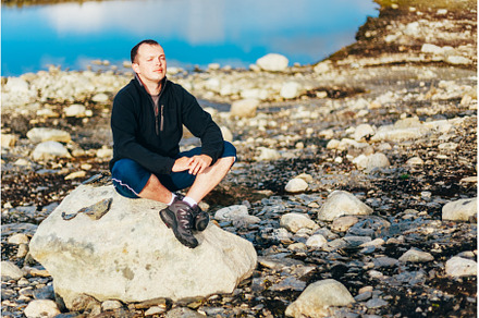 Man Sitting On Stone In Norwegian, a Nature Photo by Our Amazing World