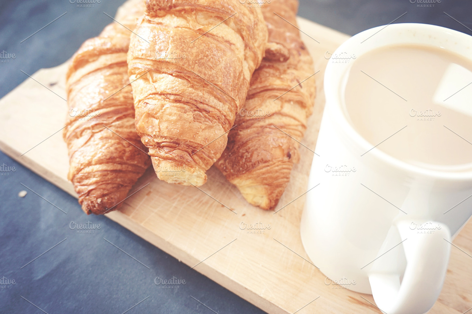Croissants and coffee featuring croissant, coffee, and wood