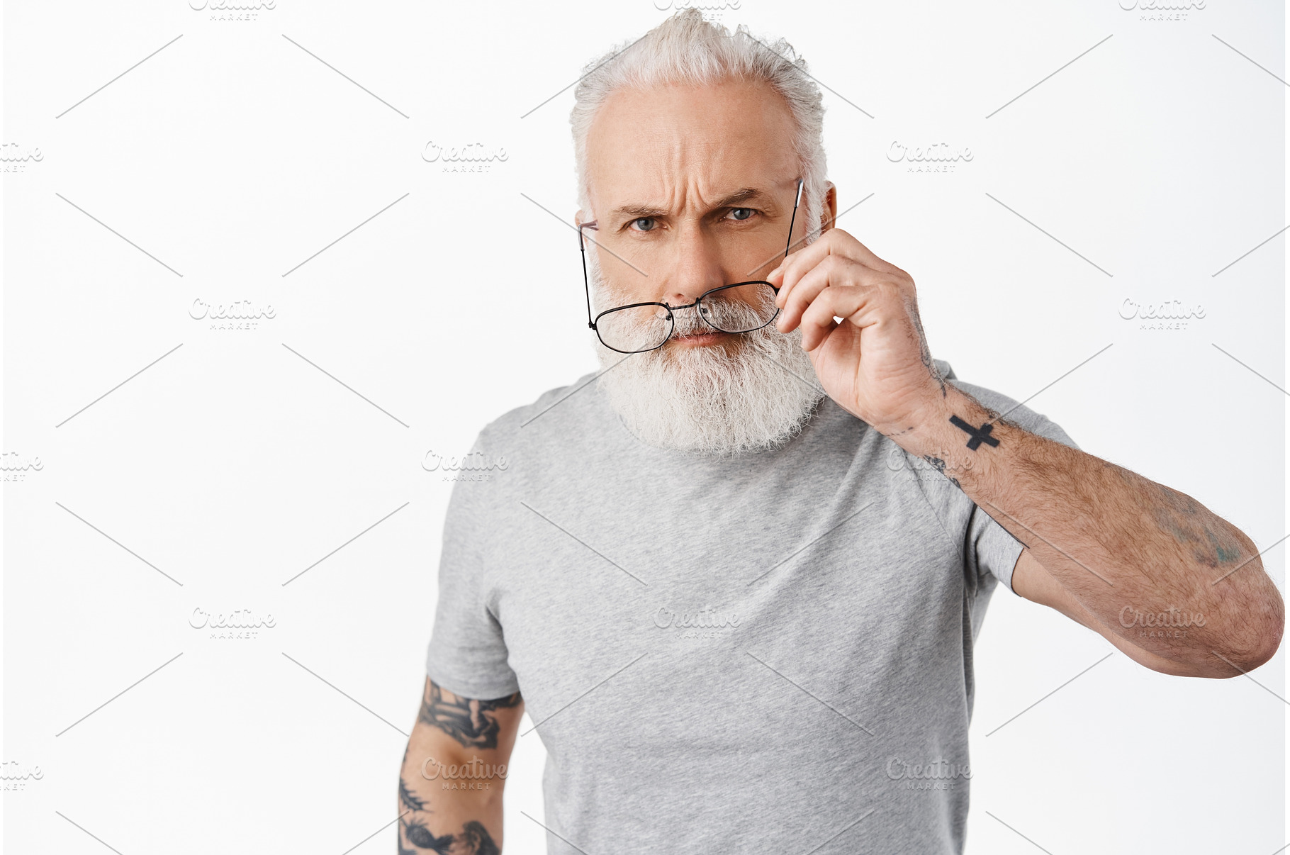 Suspicious old man with tattoos, a Person Photo by Cookie Studio