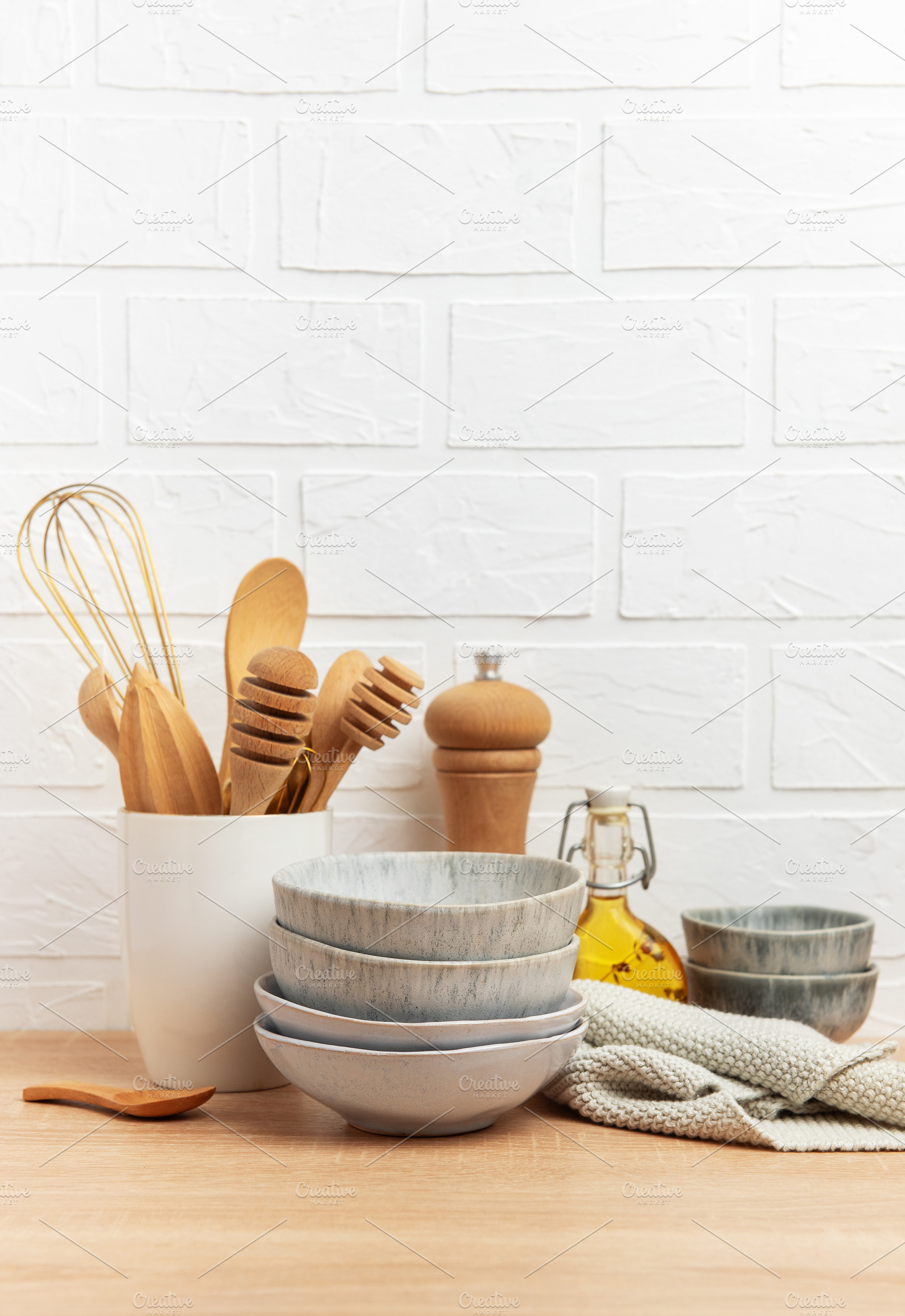 Kitchen utensils, bowls and ingredients resting on wooden counte, a Food & Drink Photo by Olena Rudo
