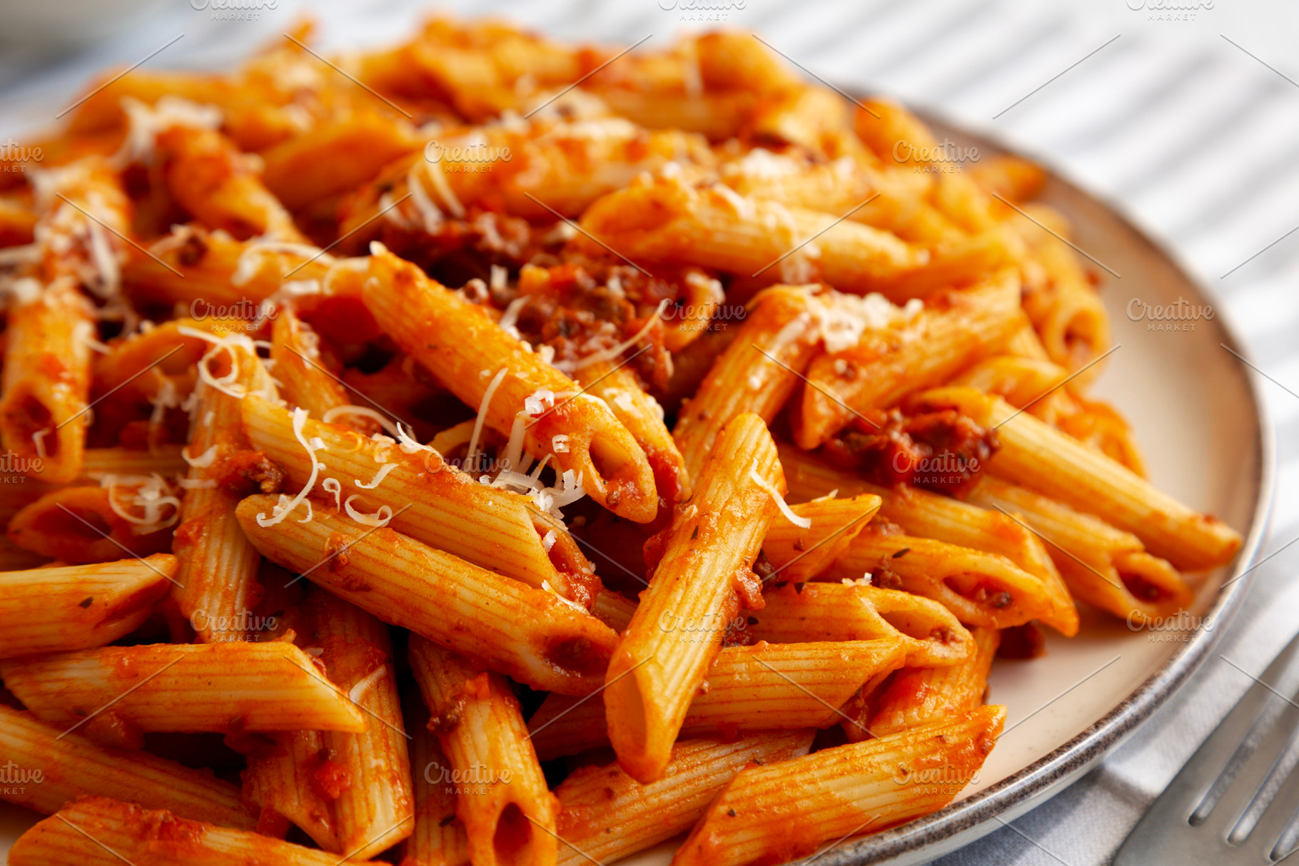 Homemade Pasta Bolognese with Cheese on a Plate, side view. Clos, a Food & Drink Photo by LiudmylaChuhunova