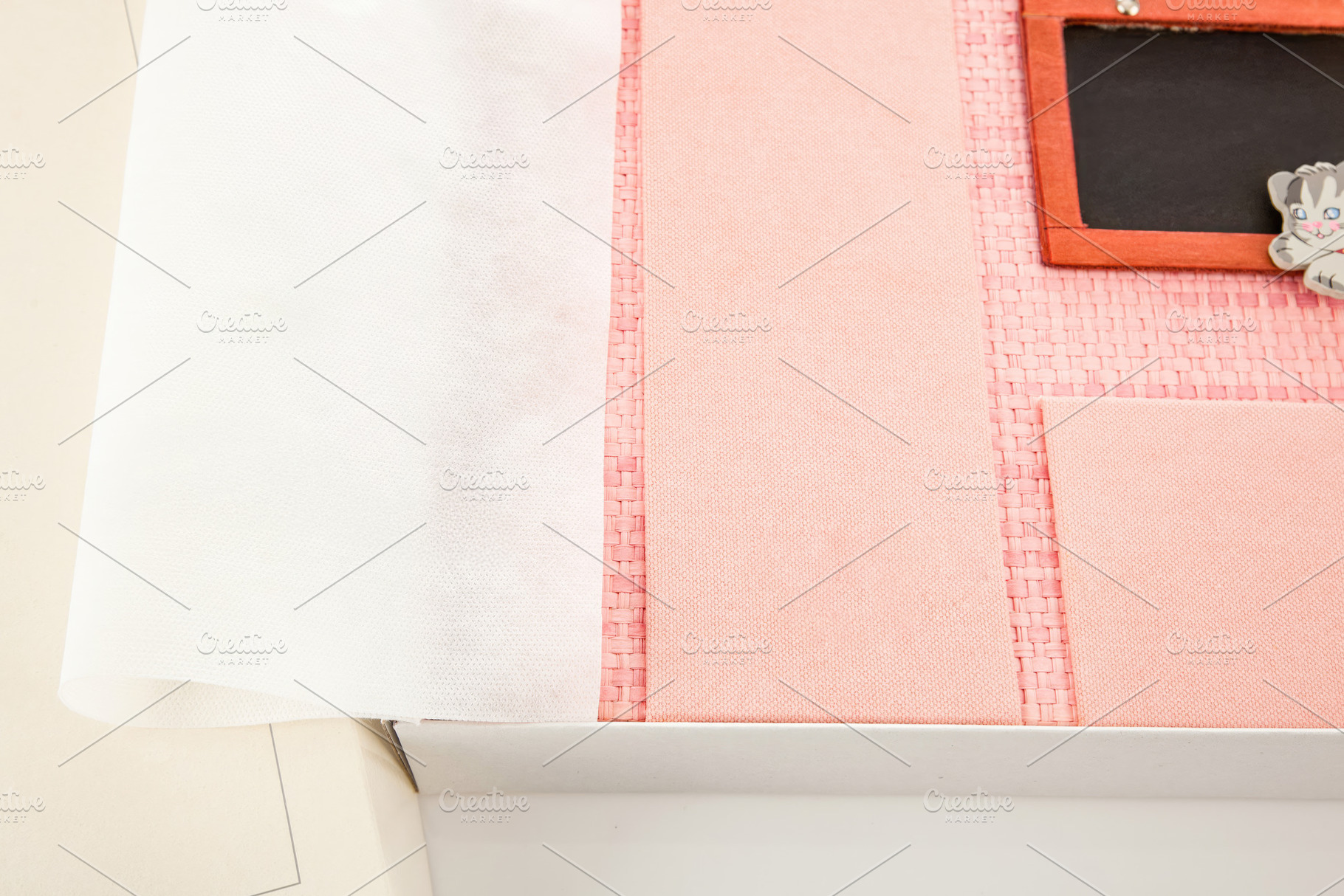 Pink photo album with protective sheet and small blackboard inside its box, an Abstract Photo by Antonio Gravante Market