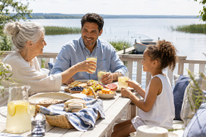 Family enjoying outdoor brunch by se, a Photo by Dvoevnore photos