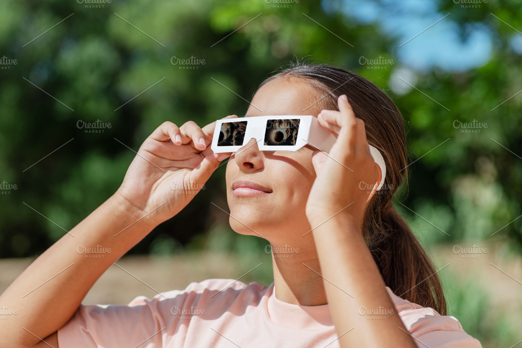 Young girl watches a solar eclipse, a Person Photo by Volff
