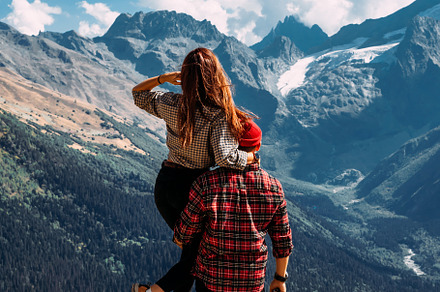 A man and a woman in the mountains, a Person Photo by SOTNIKOV_MISHA