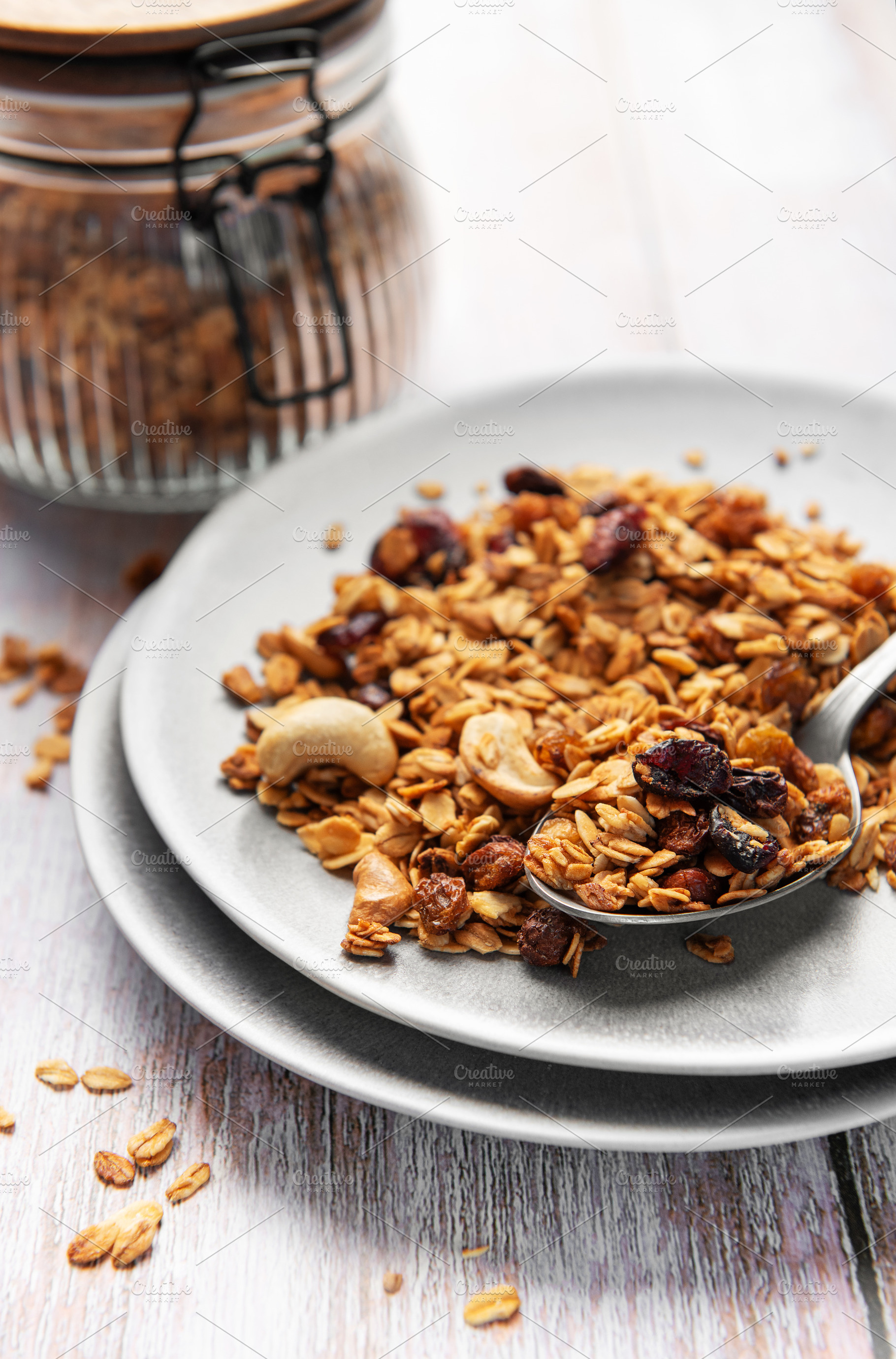 Healthy homemade granola mix on plate with spoon, a Food & Drink Photo by Olena Rudo