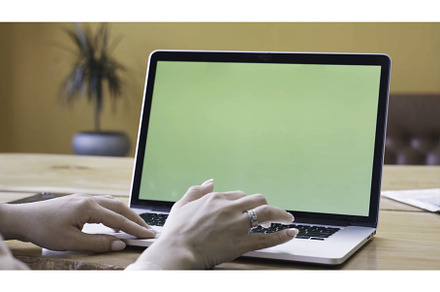 Young woman in pink shirt sitting at, a Technology Photo by Media Whale Stock