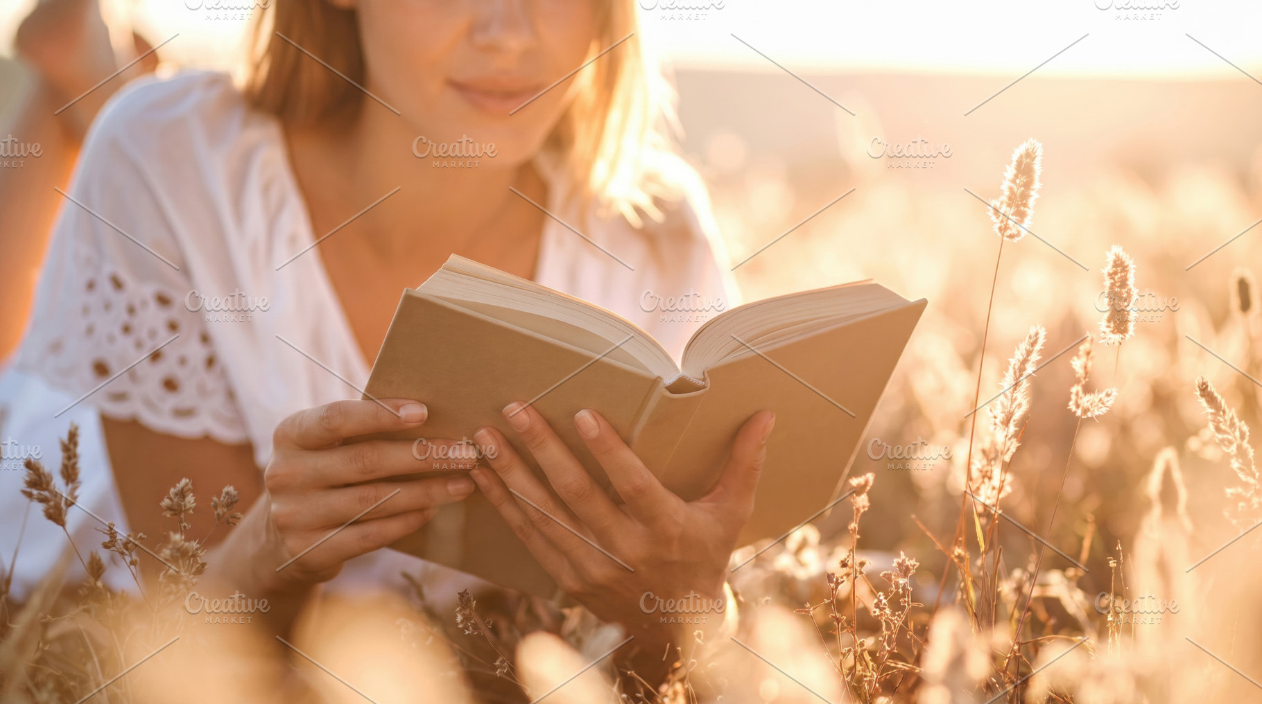 Young Woman Reading Book in Golden Meadow, a Photo by Davizro's Market