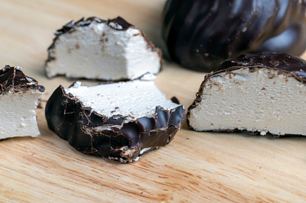 white creamy marshmallows in milk chocolate, close up, a Background Photo by MyPhotos