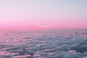 Pink sunset sky with new moon