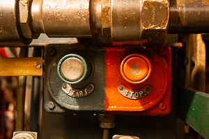 Start and stop buttons inside an old military submarine control, an Architecture Photo by GoodGoods
