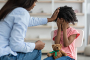 African american woman comforting emotional curly girl preschooler, clinic inte, a Photo by Prostock-Studio (Thumbnail 2 of 2)