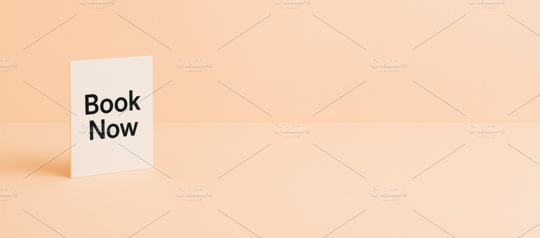 Simple card with Book Now text on pe, a Photo by Dvoevnore photos