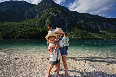 Four children in Lake Bohinj, the largest lake in Slovenia, part, a Background Photo by AS photostudio