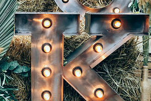 Illuminated metal letter K against a, a Photo by Dvoevnore photos
