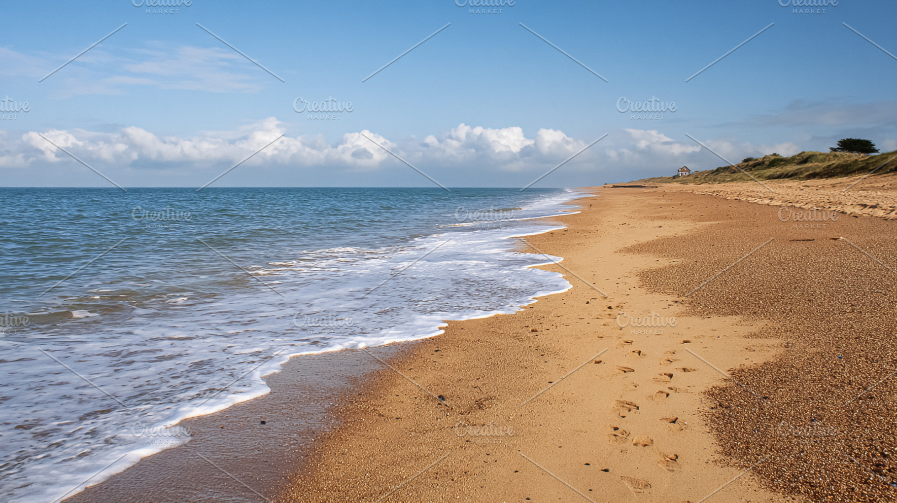 Empty sandy beach with gentle ocean waves rolling to the shore u, a Photo by Studio ANNA