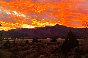 Stunning Utah sunset over desert landscape with orange sky and rugged mountains, a Nature Photo by AS photostudio