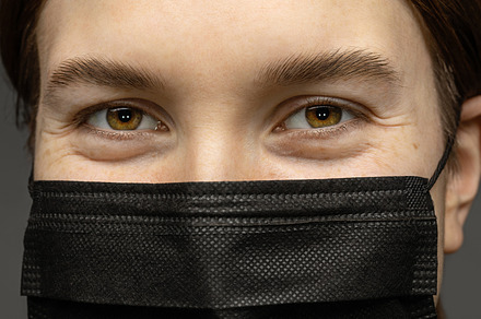 Girl in a black medical mask.