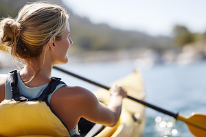 Young woman kayaking on a sunny day, a Sports & Recreation Photo by MistyDay