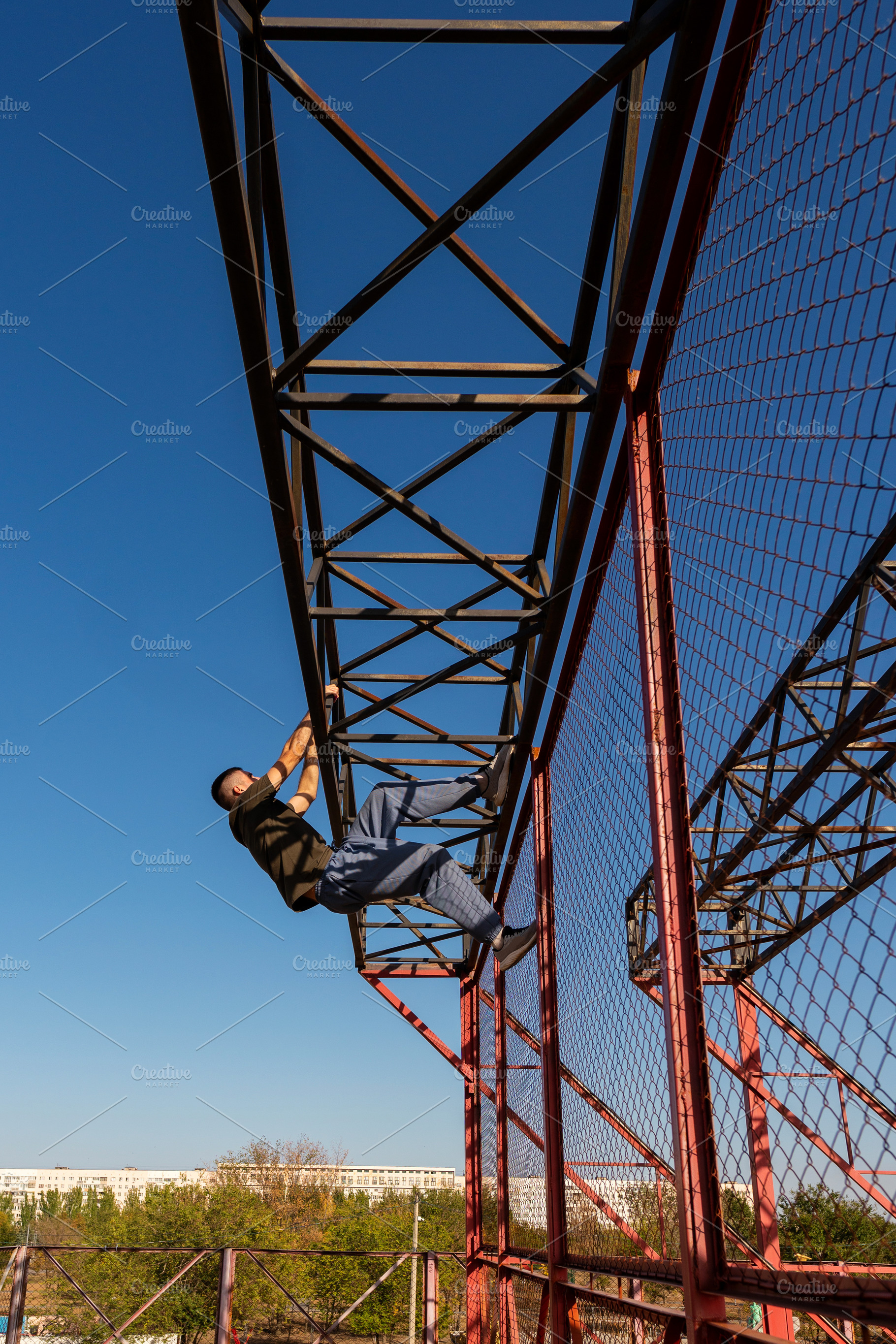 Freerunner man climbing metal struct, a Sports & Recreation Photo by Elena Vagengeim