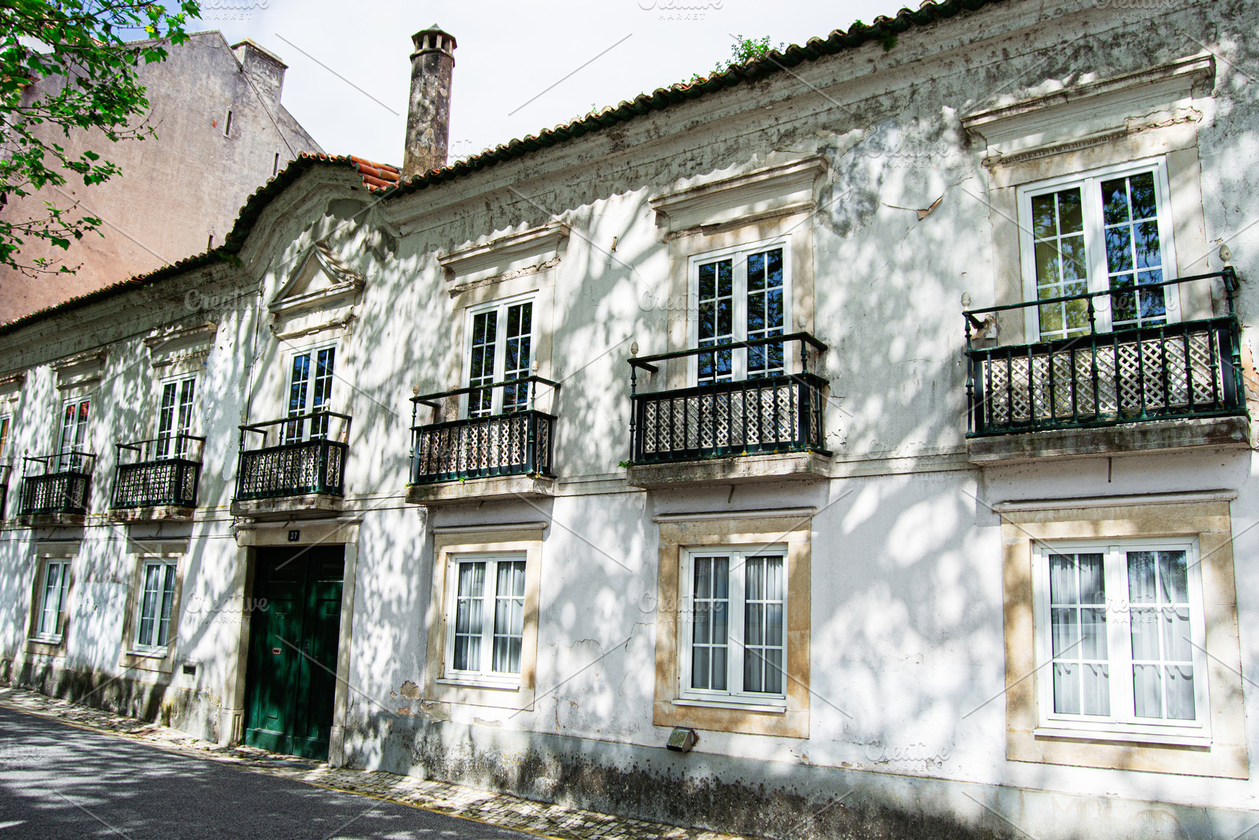 Historic building facade with balconies in Caldas da Rainha, Portugal on a brig, a Photo by AS photostudio