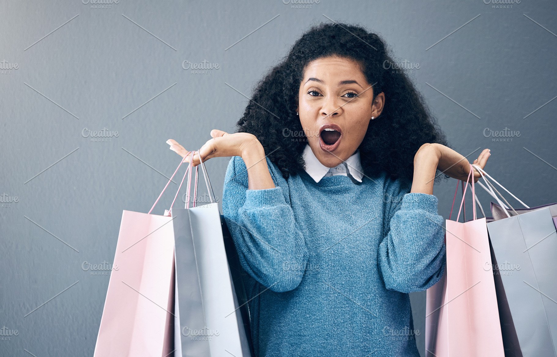 Wow, discount and portrait of woman with shopping bags, retail therapy and surprise at sale on wall. Deal, excited and happy girl holding products from a shop, market or mall on a background, a Photo by Peopleimages.com