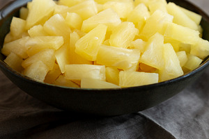 Canned Pineapple Tidbit Chunks in a Bowl, side view., a Food & Drink Photo by LiudmylaChuhunova