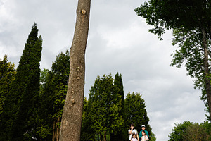Family standing together outdoors amidst tall trees and lush greenery under clo, a Person Photo by AS photostudio