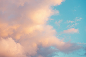 Sunset with blue sky and pink clouds containing golden, sunshine, and