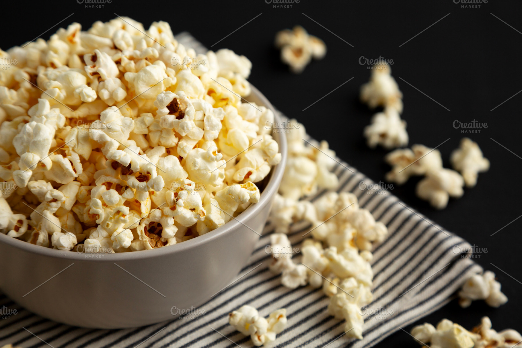 Homemade Butter Popcorn with Salt in a Bowl, side view., a Food & Drink Photo by LiudmylaChuhunova