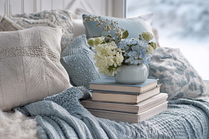 Winter hygge window seat creating a cozy reading nook with pillo, a Photo by Studio ANNA