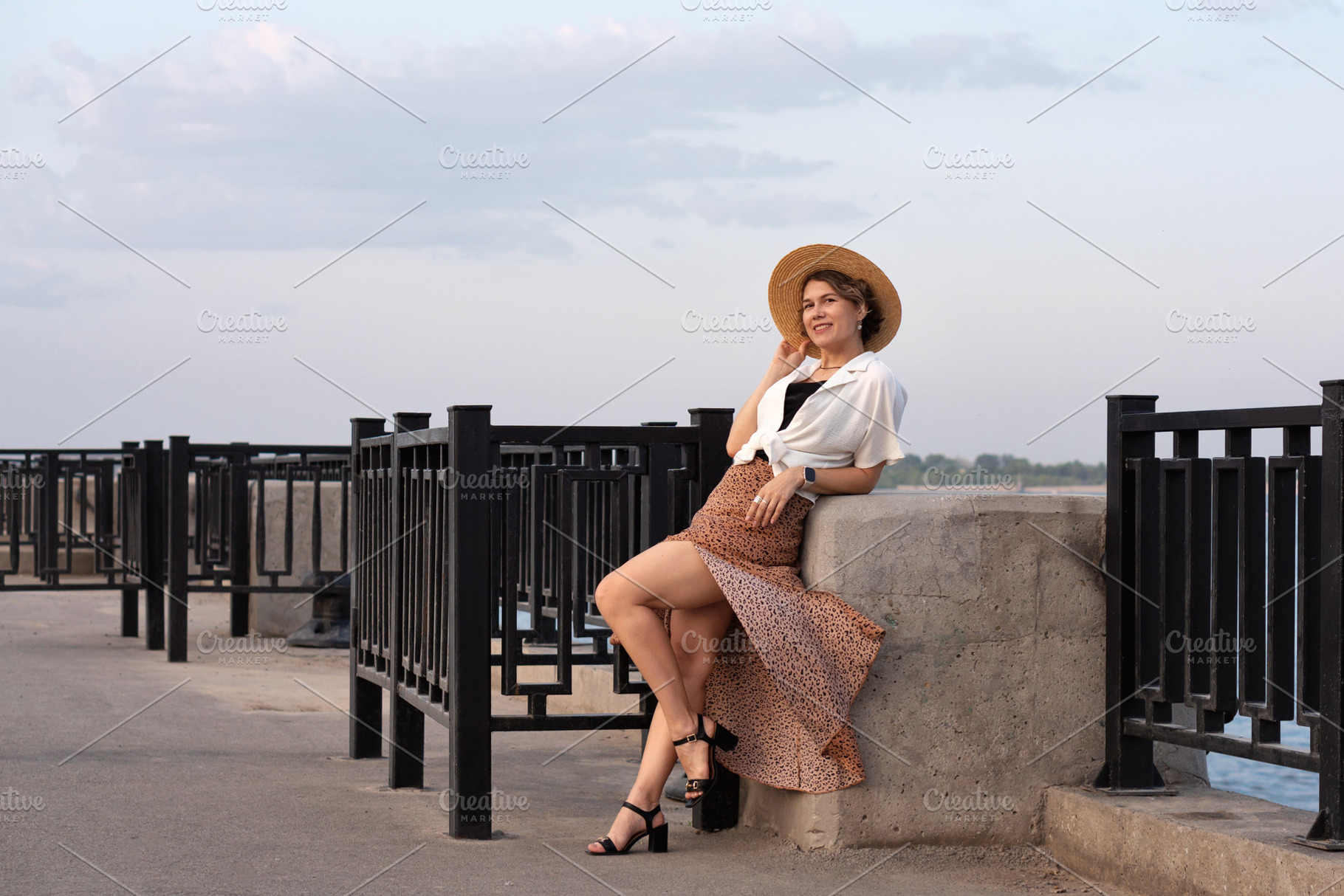 Woman smiles while leaning on stone, a Person Photo by Elena Vagengeim
