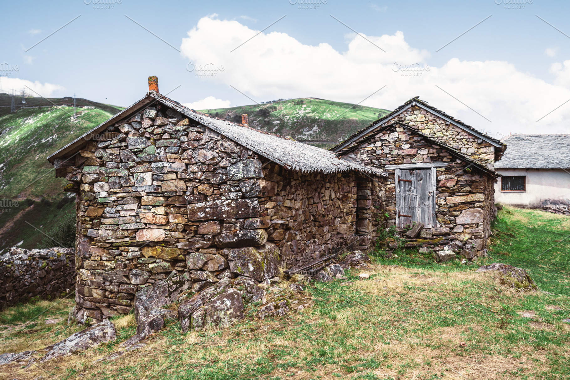 Rustic stone huts in mountain meadow, an Architecture Photo by SkyNext