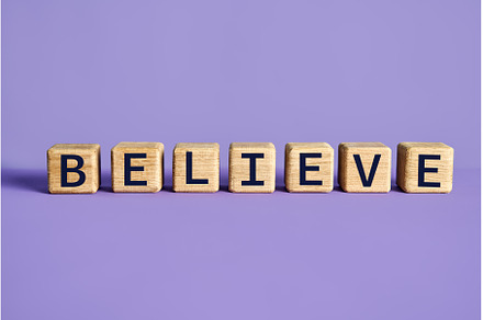 The word BELIEVE on wooden blocks