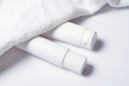 White plastic tube for cosmetic with terry towel, minimalistic c