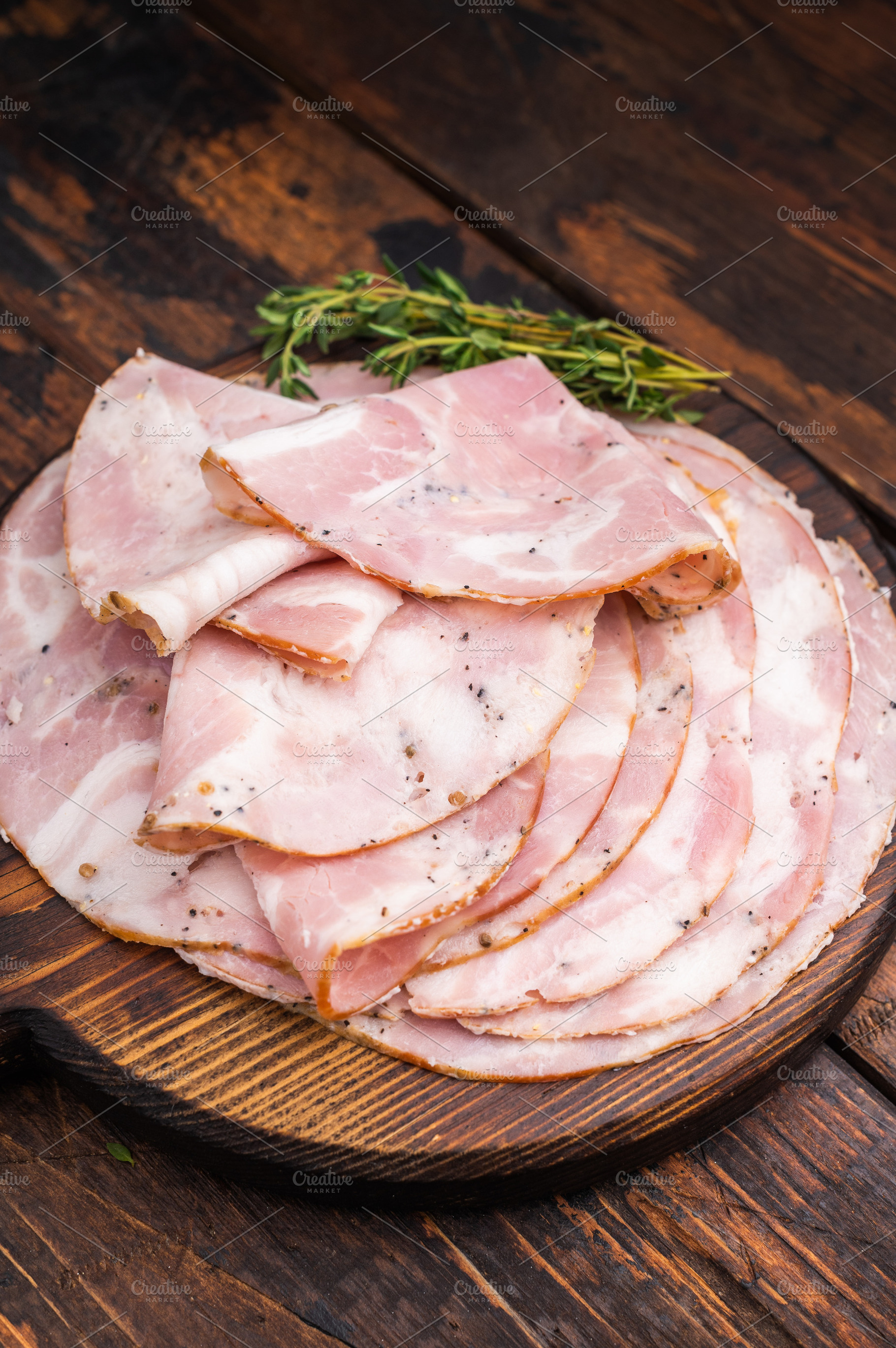 Slices of authentic Italian Pancetta Arrotolata served on a dark, a Food & Drink Photo by composter-box@mail.ru