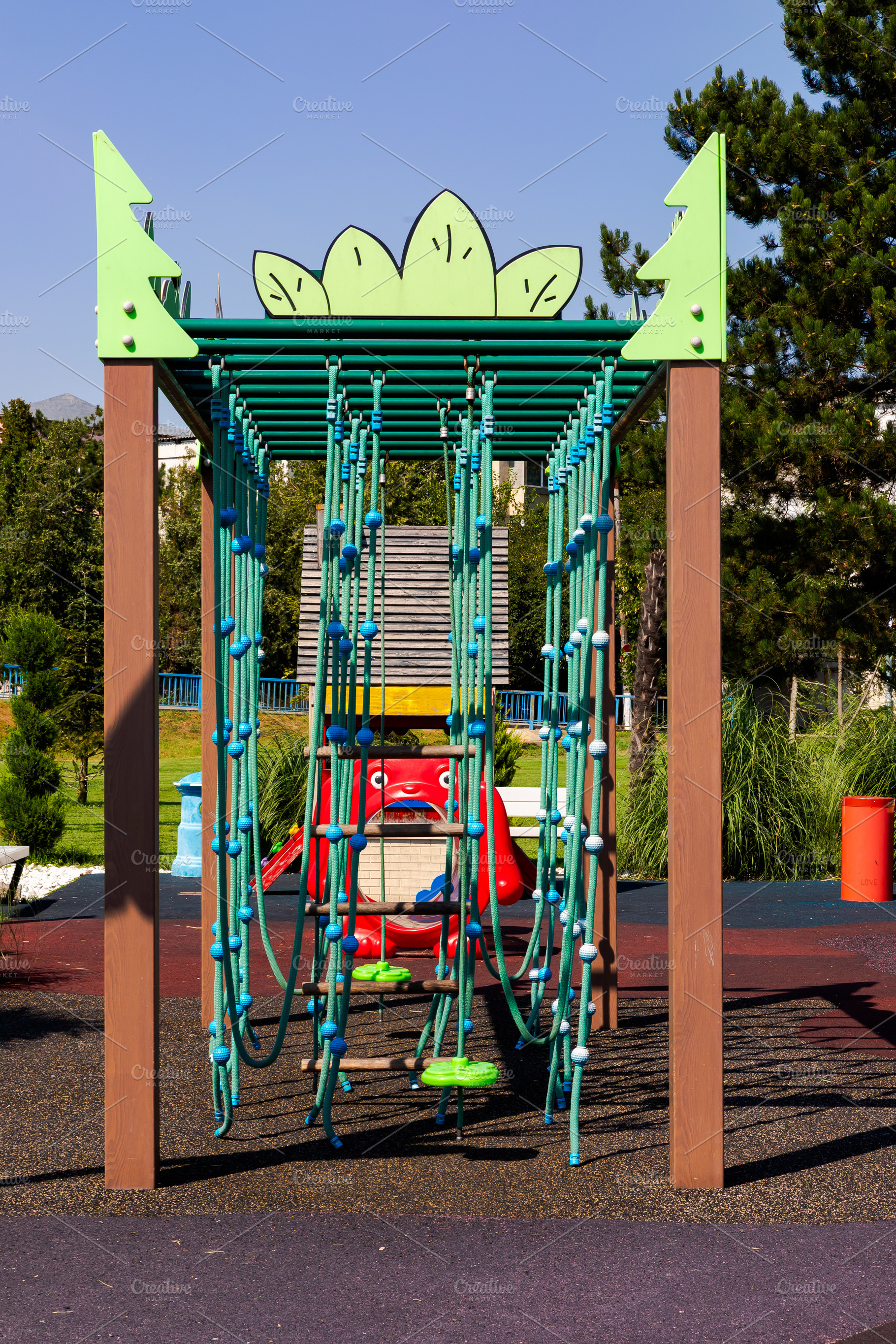 Colorful playground climbing frame with ropes and playful design in a sunny par, a Sports & Recreation Photo by Ales Munt