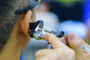 Patient is seen by an otolaryngologist. ENT doctor examines a pa, a Health & Medical Photo by Casanowe-studio