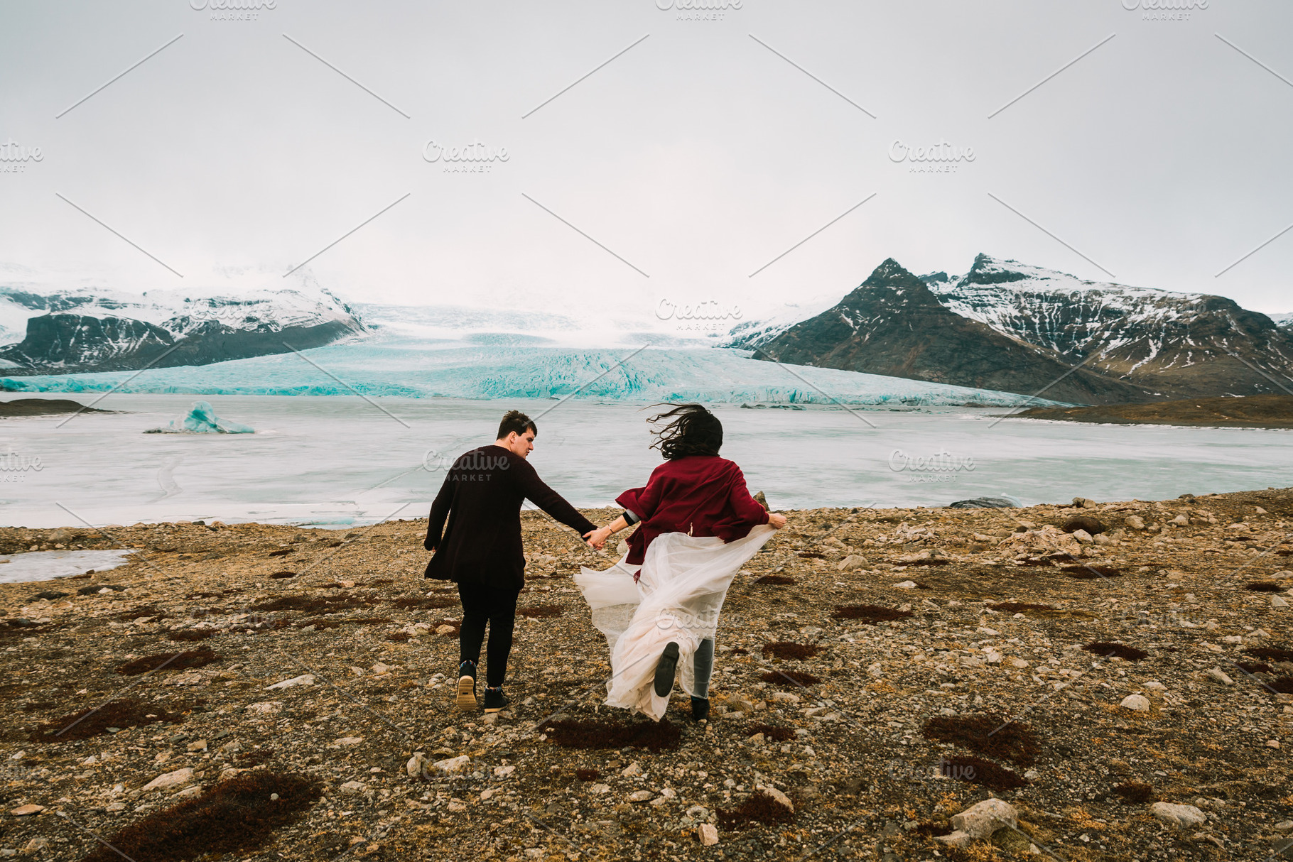 Bride and groom runs together iceland wedding in glacier lagoon rear view, a Person Photo by Stahov