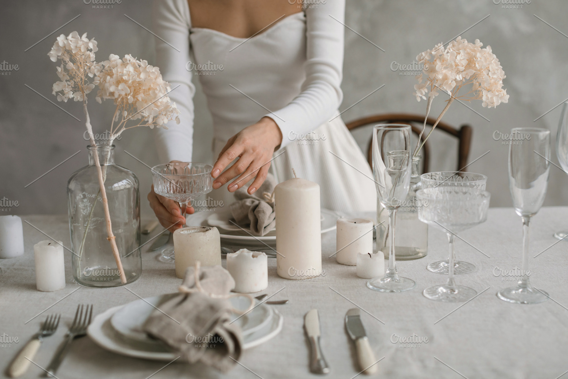 Woman setting stylish table, a Food & Drink Photo by Nina Stock Photos