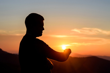 Silhouette of young man on the mountain in the evening using wat, a Person Photo by Byrdyak