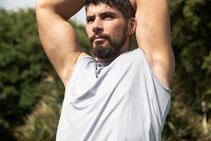 Young athletic man stretching outdoors in a park before workout, a Sports & Recreation Photo by etorres69